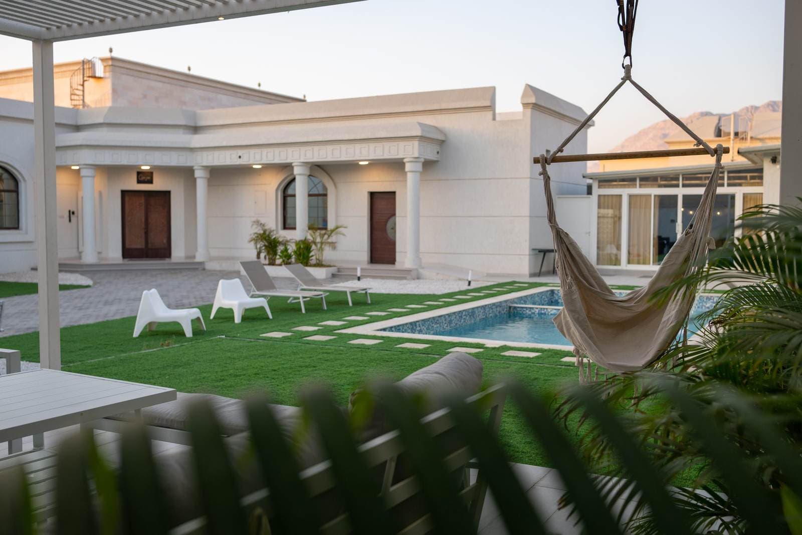 Villa exterior with poolside swing